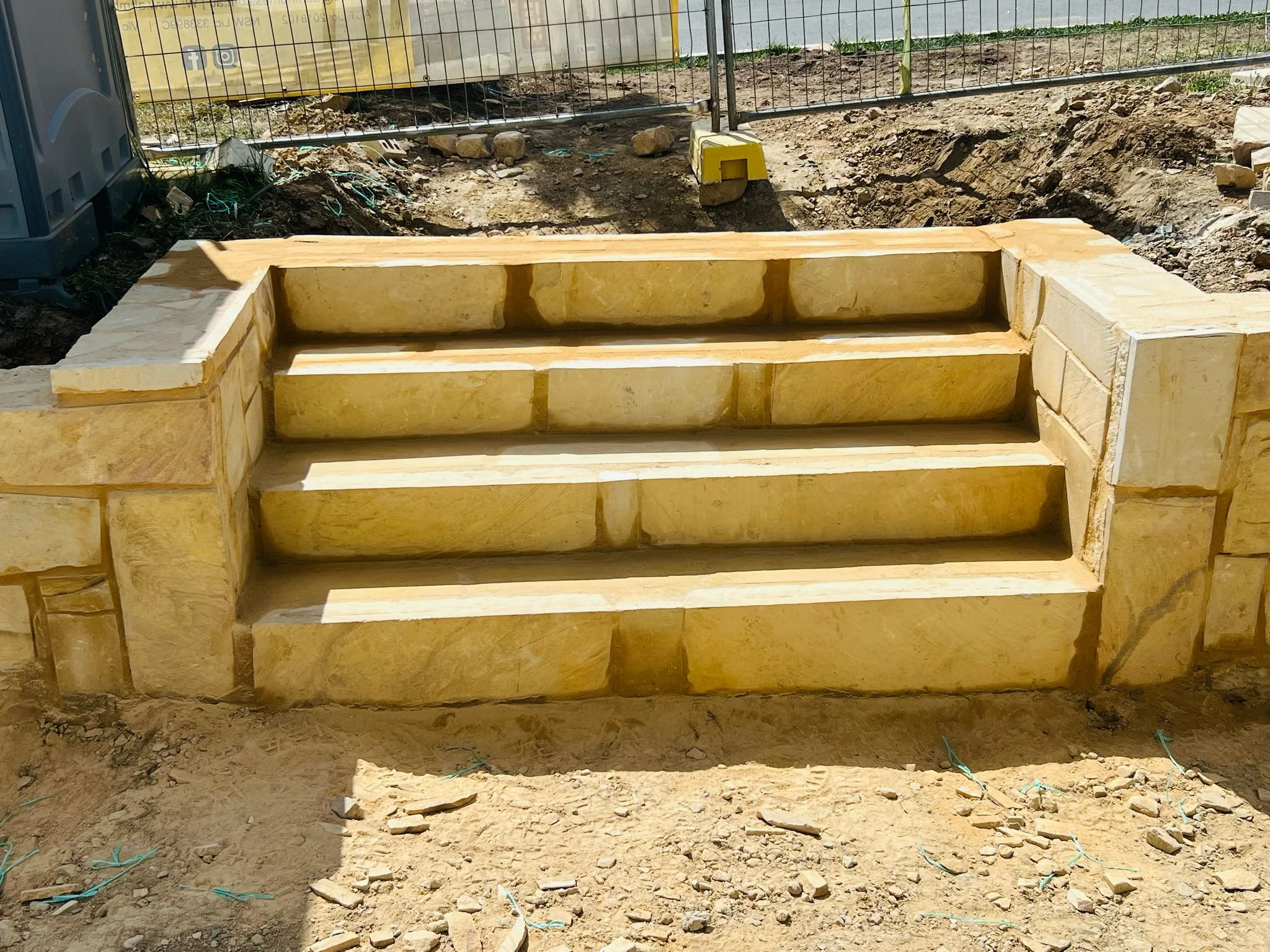Outdoor kitchen area with built-in grill and seating