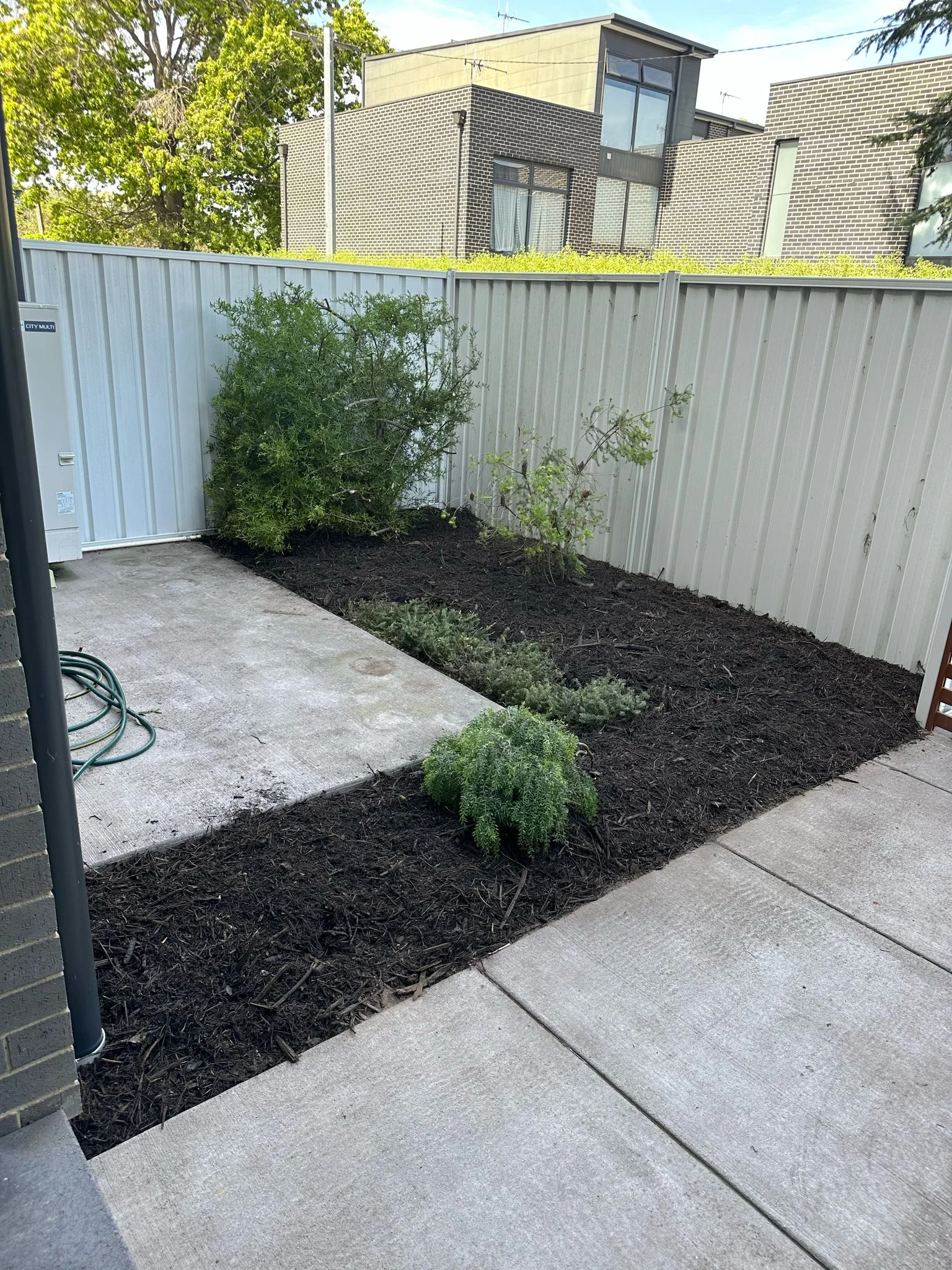 Beautifully landscaped backyard with a modern patio and lush greenery